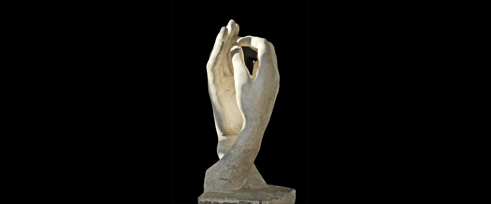 The Cathedral (1908) by Auguste Rodin. Two right hands, from two different figures, held a fraction of an inch apart — neither grasping nor guiding, just meeting.